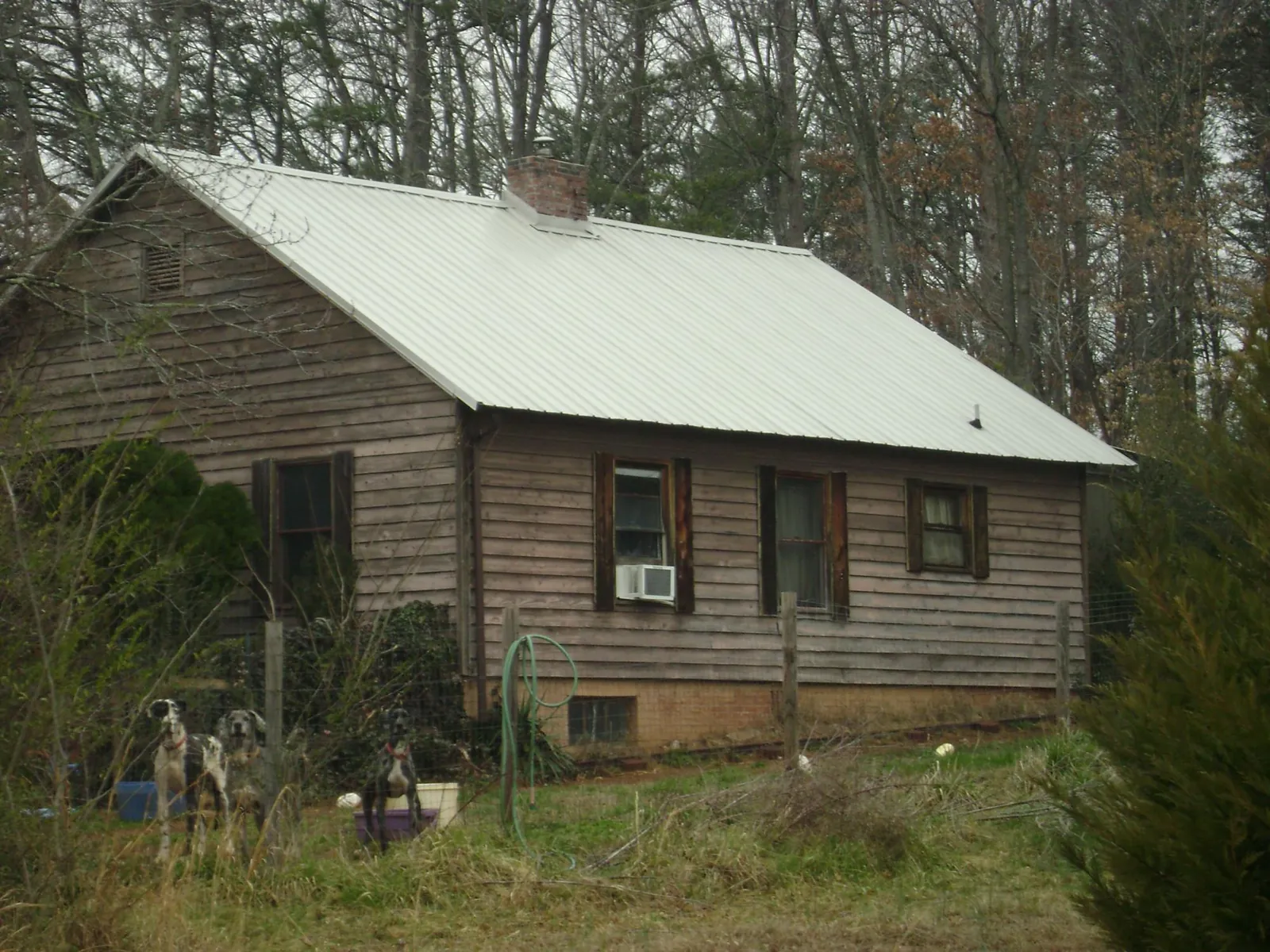 White metal roof on an old wood sided farmhouse, from a Metal Roof Installation job in Harrison City